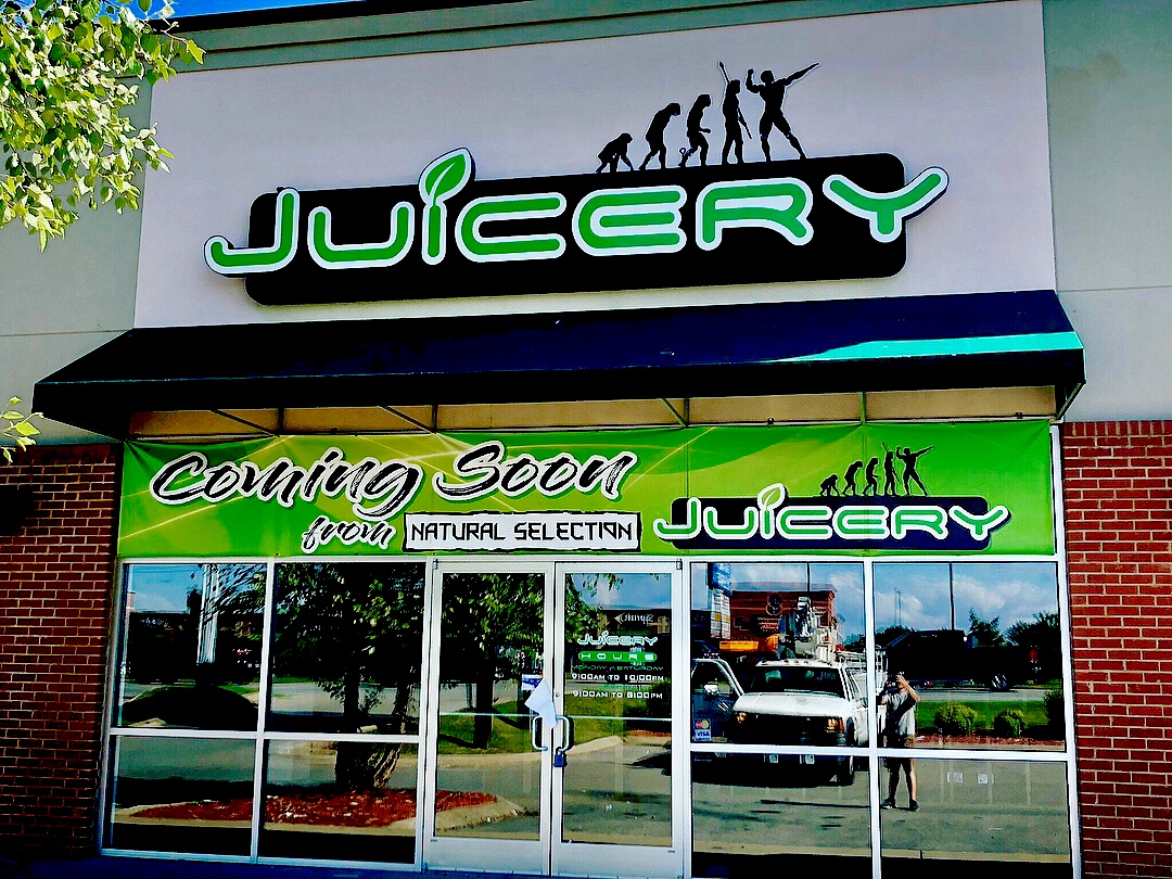 juicery sign and decals on building